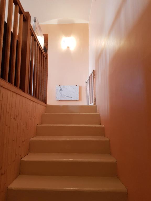 a set of stairs in a building with a light at Gîte Micha in Saint-Lothain