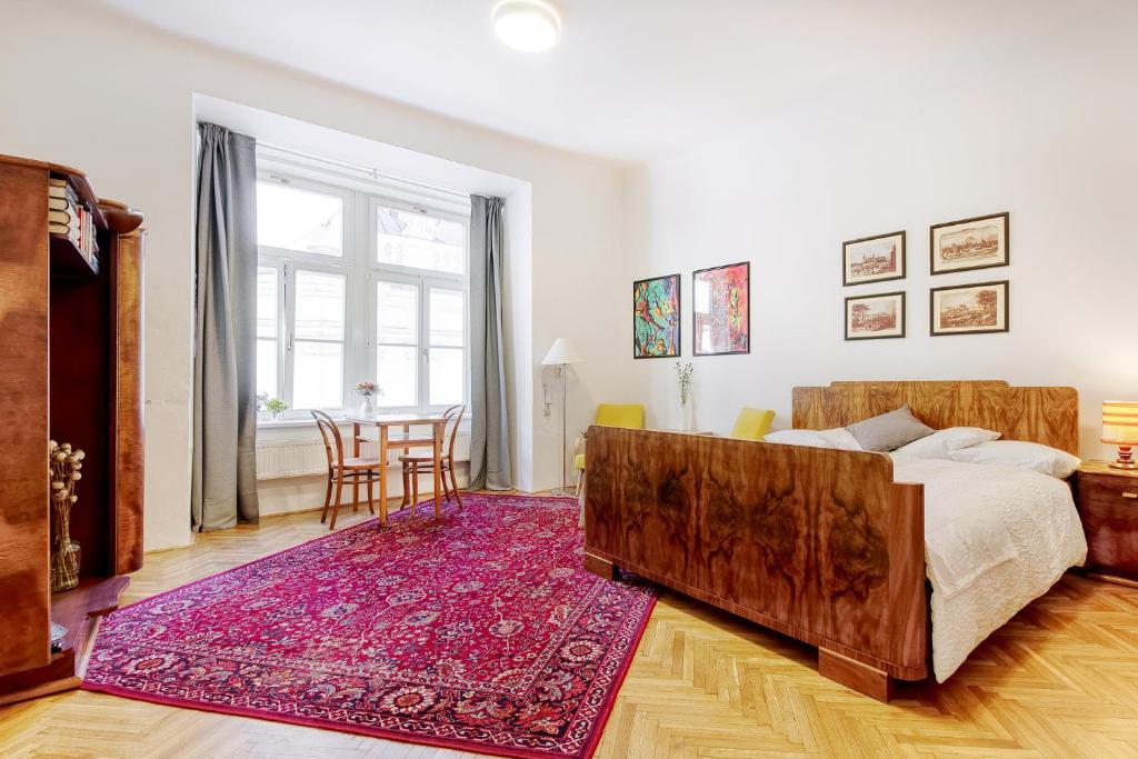 een slaapkamer met een groot bed en een tafel bij At the Three Princes in Brno