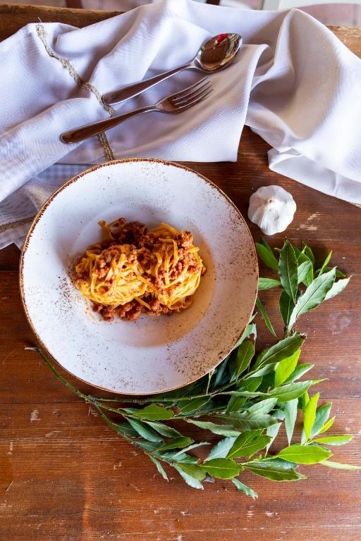 a bowl of pasta on a table with a napkin at Agriturismo La Mignola in Quercianella