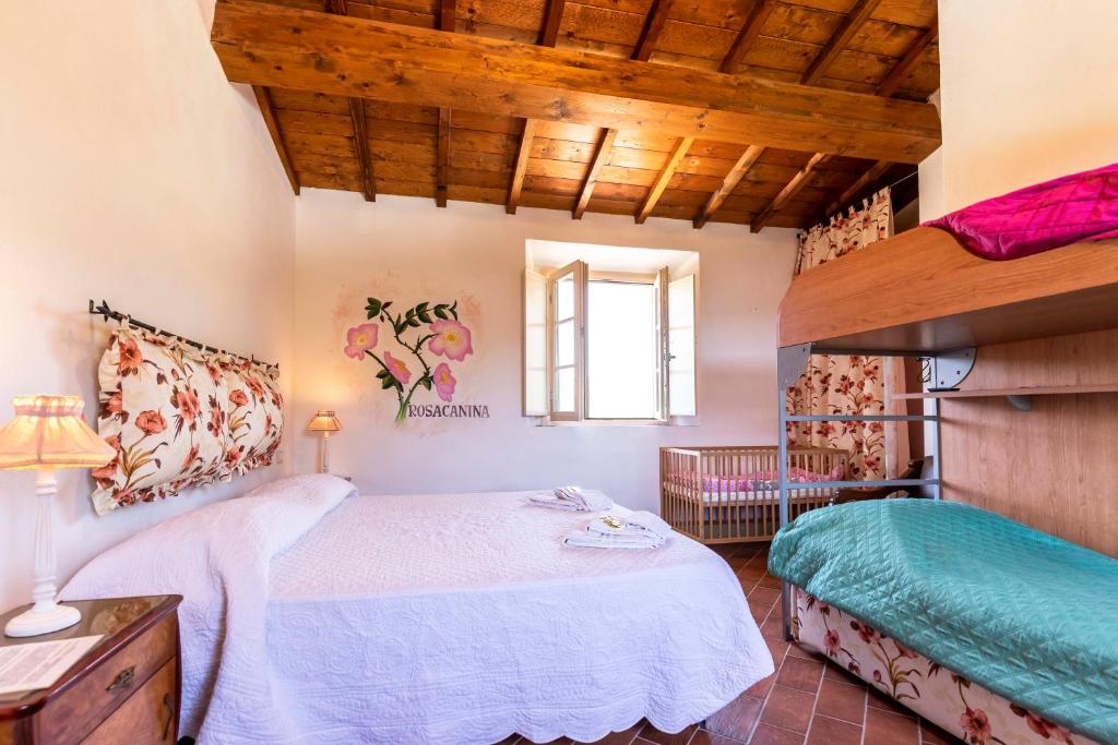 a bedroom with a large bed and a loft bed at Agriturismo La Mignola in Quercianella