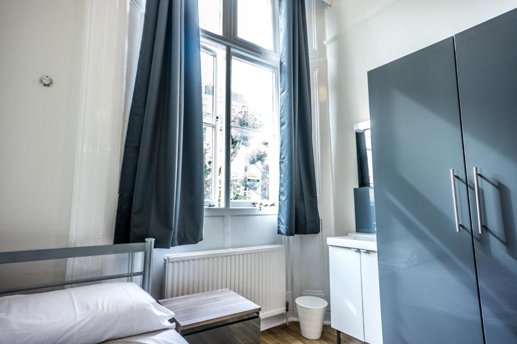 Postel nebo postele na pokoji v ubytování Sandeman-Allen Hostel (Bayswater)