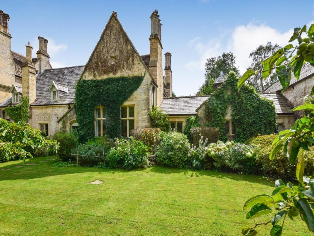 an old stone house with a grass yard at Bellhouse in Stonehouse