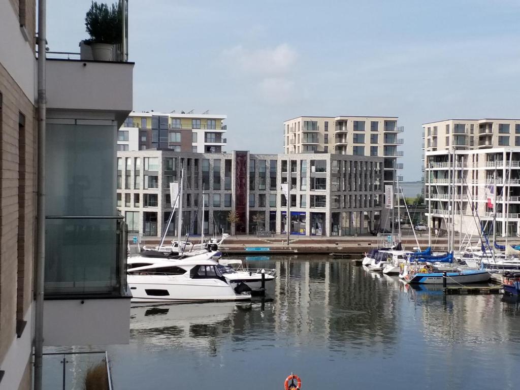 a group of boats docked in a harbor with buildings at Heimathaven 2 in Bremerhaven