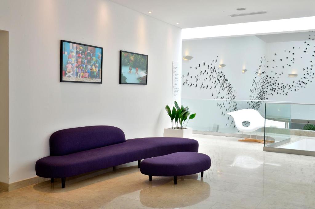 a purple chair and ottoman in a room at Pestana Cidadela Cascais - Pousada & Art District in Cascais