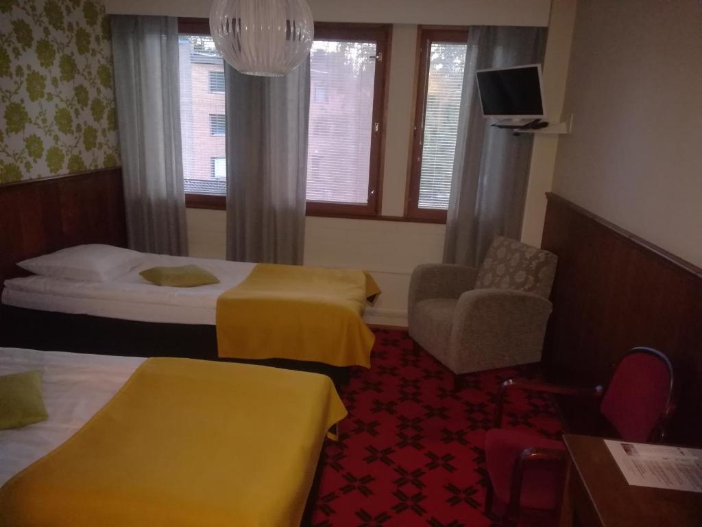 Postel nebo postele na pokoji v ubytování Hotelli Pogostan Hovi