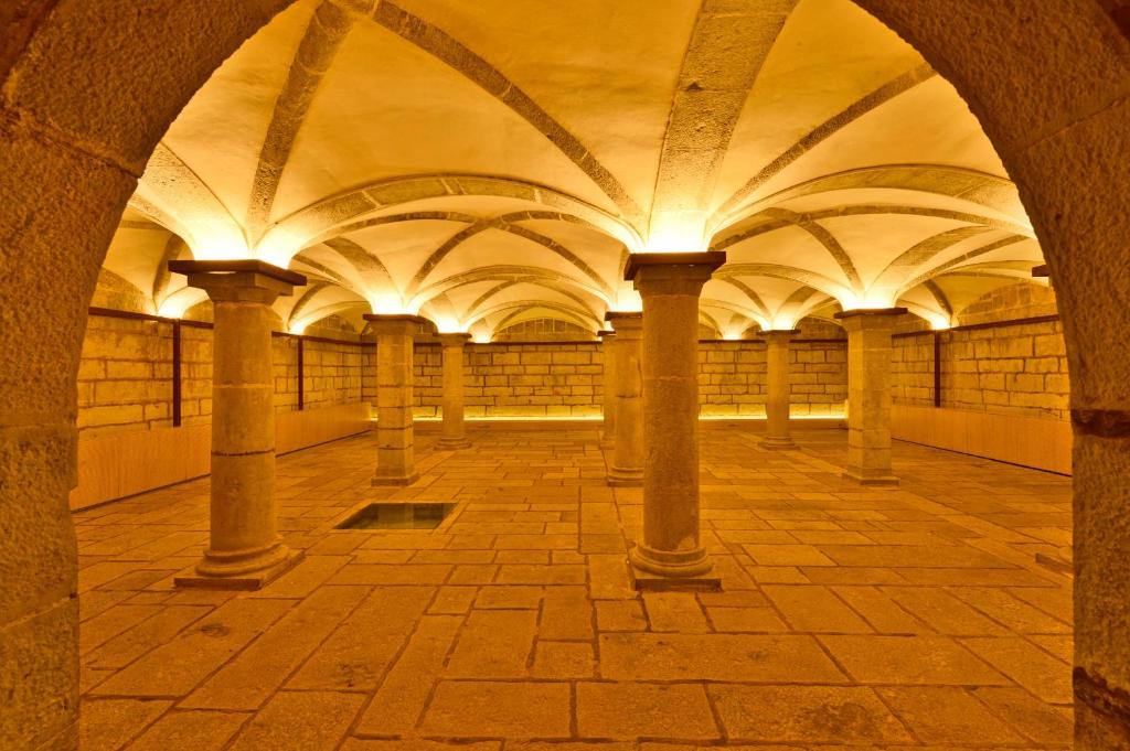 an arcade with columns and ceilings in a building at Pestana Cidadela Cascais - Pousada & Art District in Cascais