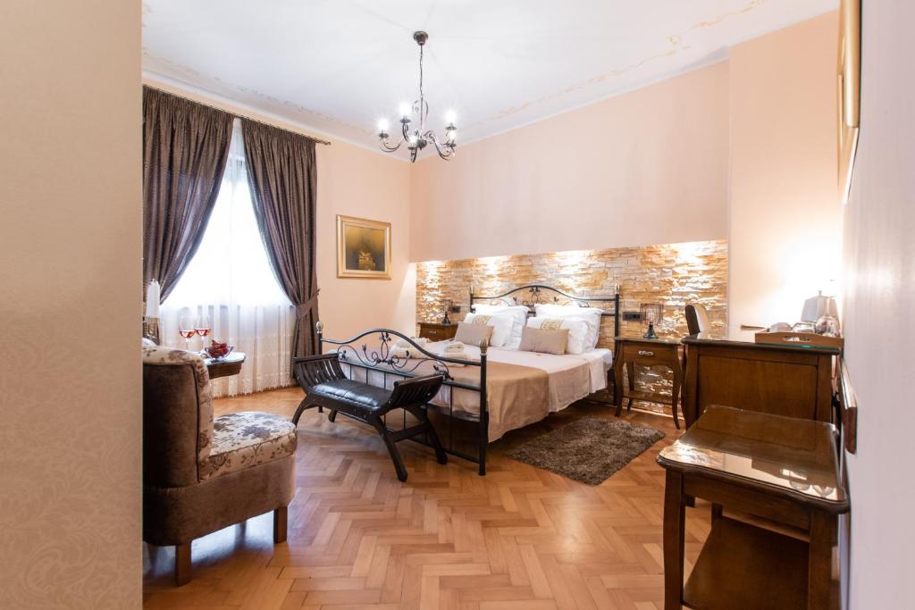 a bedroom with a bed and a desk and a chair at Unique Luxury Rooms in Split