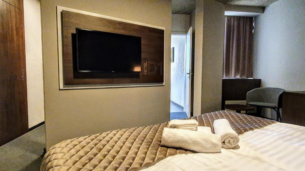 Postel nebo postele na pokoji v ubytování Hotel D1