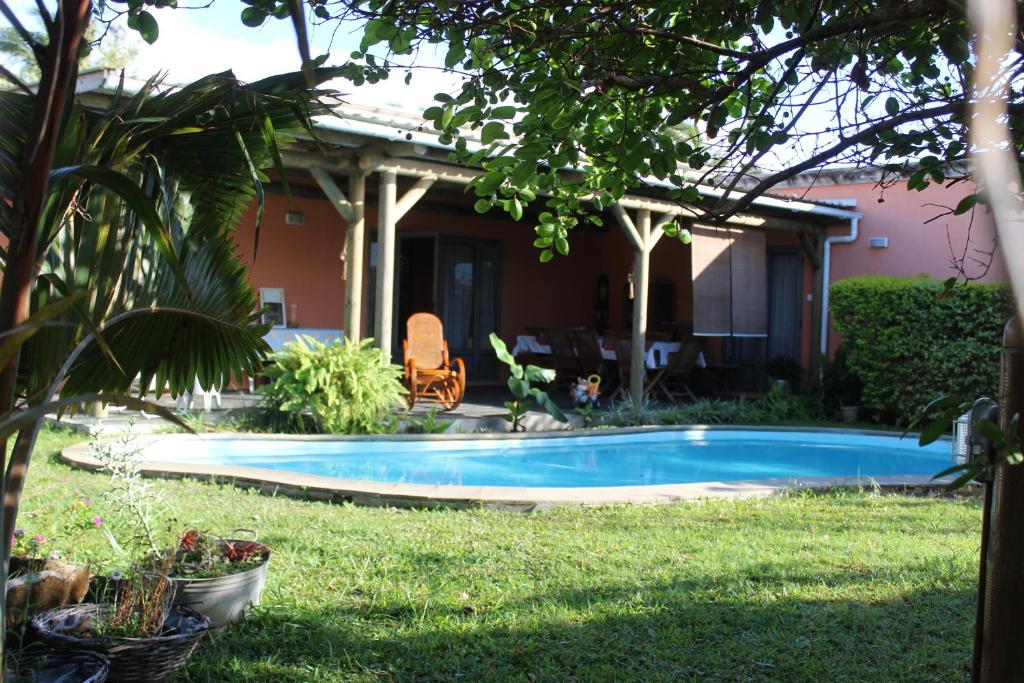 a swimming pool in the yard of a house at Gite des Acacias in Union Vale