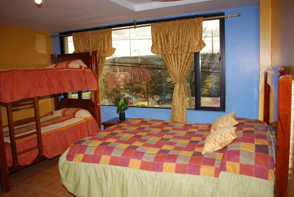Postel nebo postele na pokoji v ubytování Hotel Gran Quitumbe