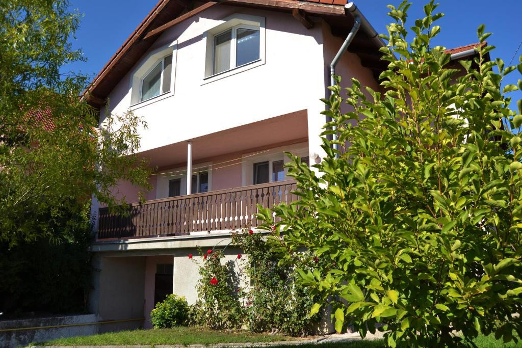 a large white house with a balcony at Granny's in Svätý Jur