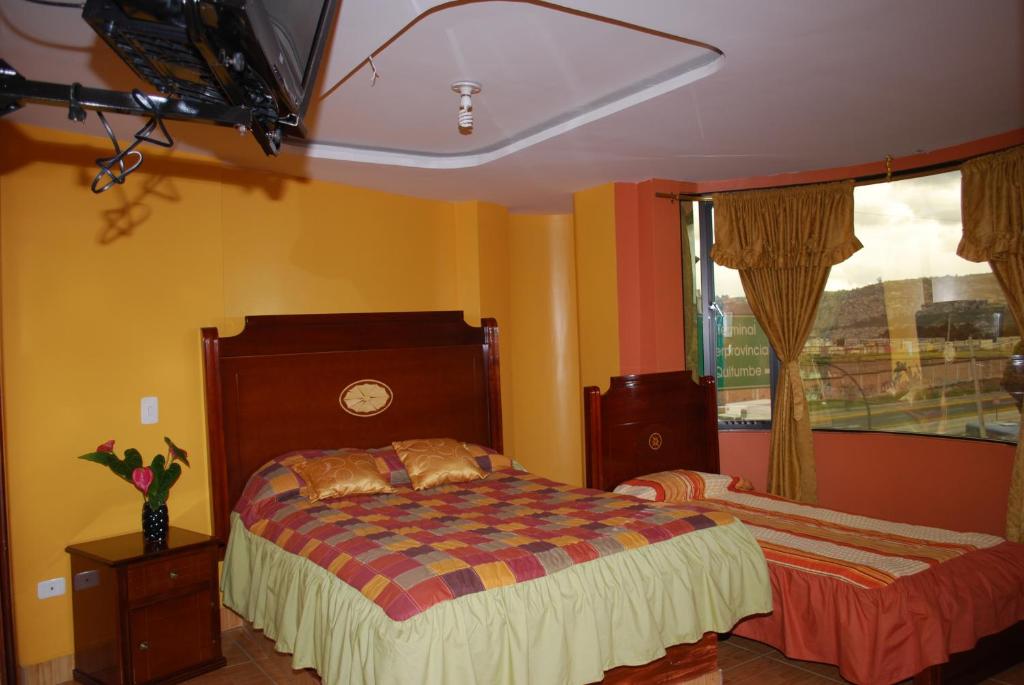 Postel nebo postele na pokoji v ubytování Hotel Gran Quitumbe