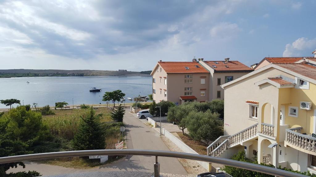 a view of a street with buildings and a body of water at Zagi in Povljana