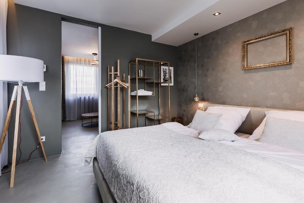Postel nebo postele na pokoji v ubytování VILLA BRICOLA - Boutique Apartments