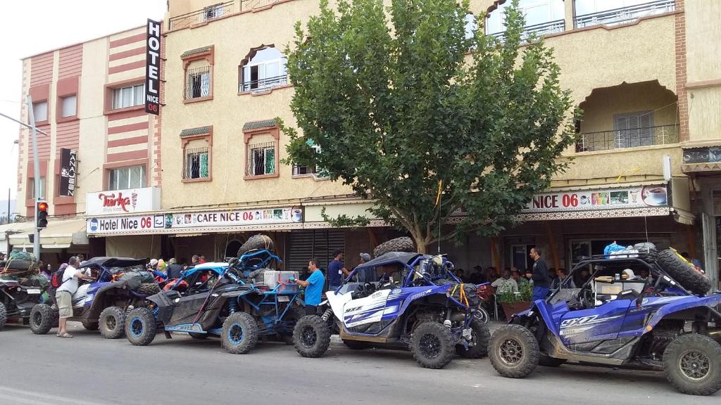 a row of four atvs parked on a city street at Hotel Nice 06 in Midelt