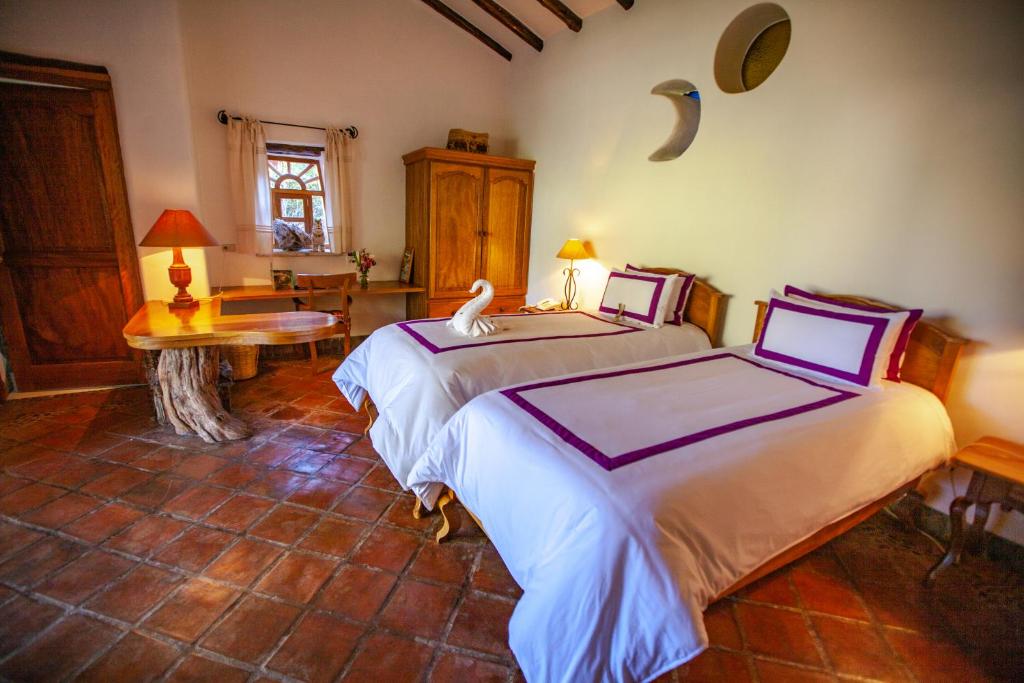 Postel nebo postele na pokoji v ubytování Las Casitas del Arco Iris