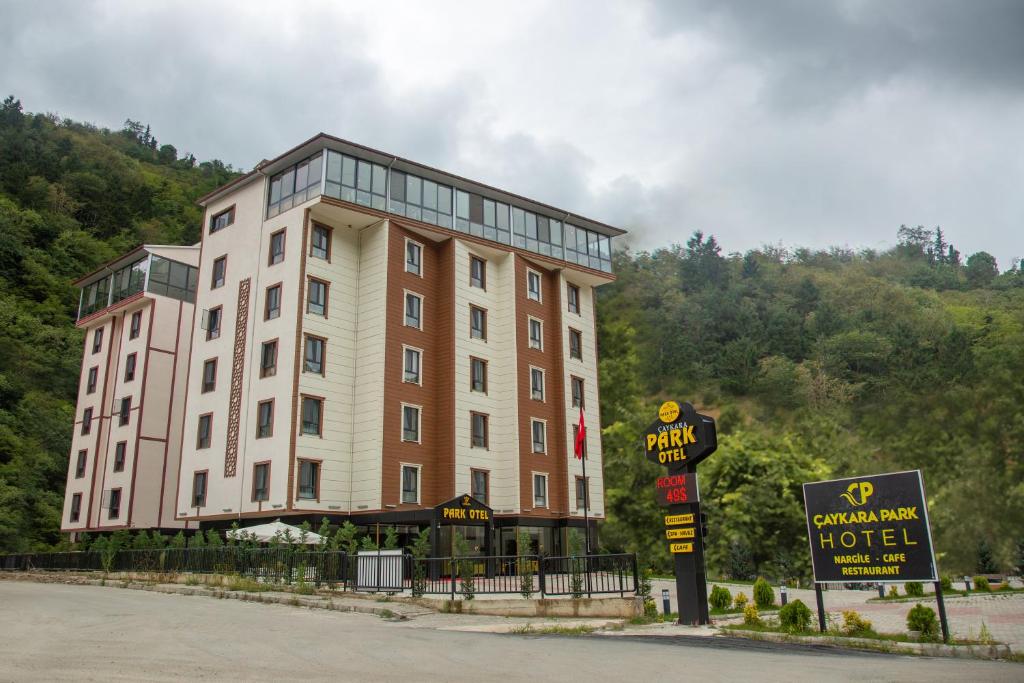 un gran edificio con una señal de hotel delante en ÇAYKARA PARK HOTEL en Çaykara
