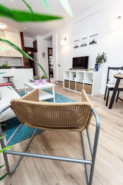 A television and/or entertainment centre at Spectacular Renovated Apartment, 5 min to Camison Beach, with AirCon