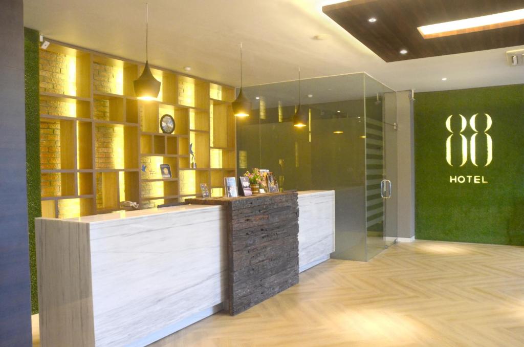a hotel lobby with a hotel sign on the wall at Hotel 88 Embong Kenongo - Kayun By WH in Surabaya