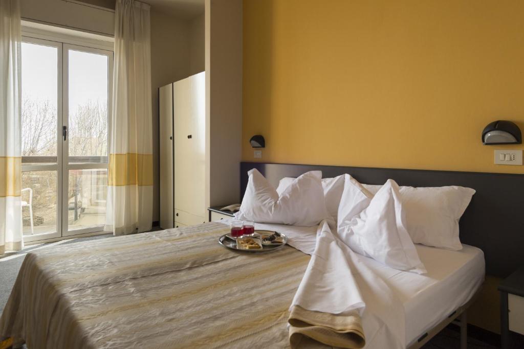 Postel nebo postele na pokoji v ubytování Hotel Airone
