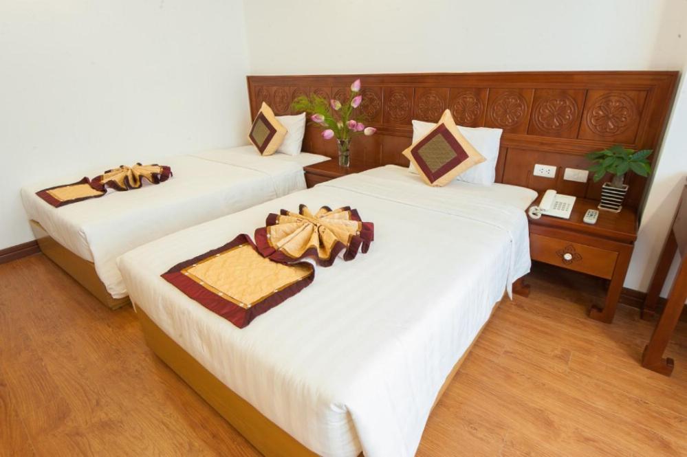 Postel nebo postele na pokoji v ubytování Lefoyer Hotel