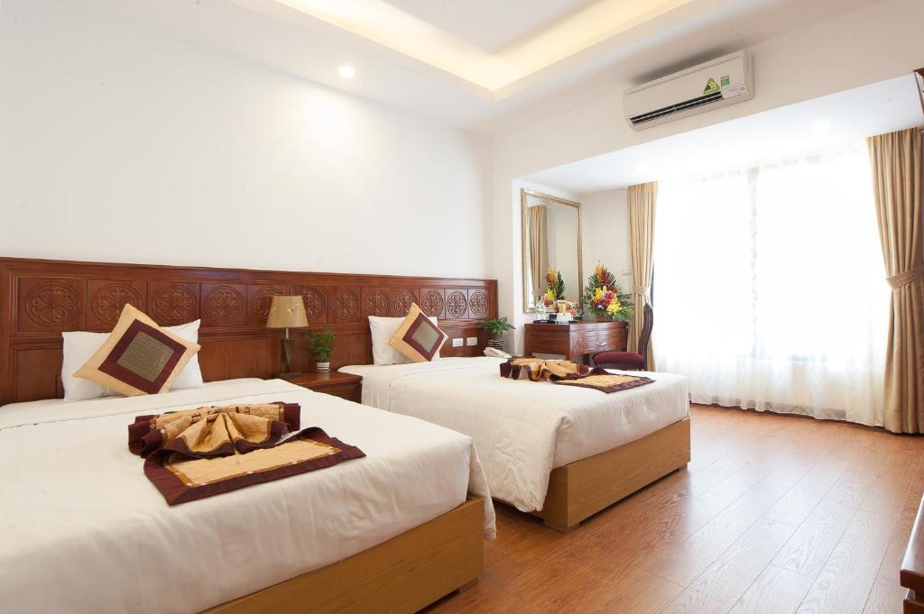 Postel nebo postele na pokoji v ubytování Lefoyer Hotel