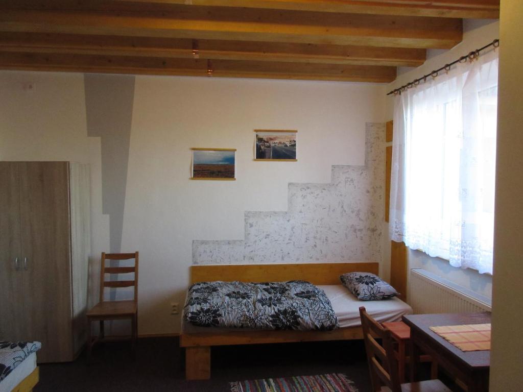 1 dormitorio con 1 cama y escalera en Penzion Shamrock en Třebíč