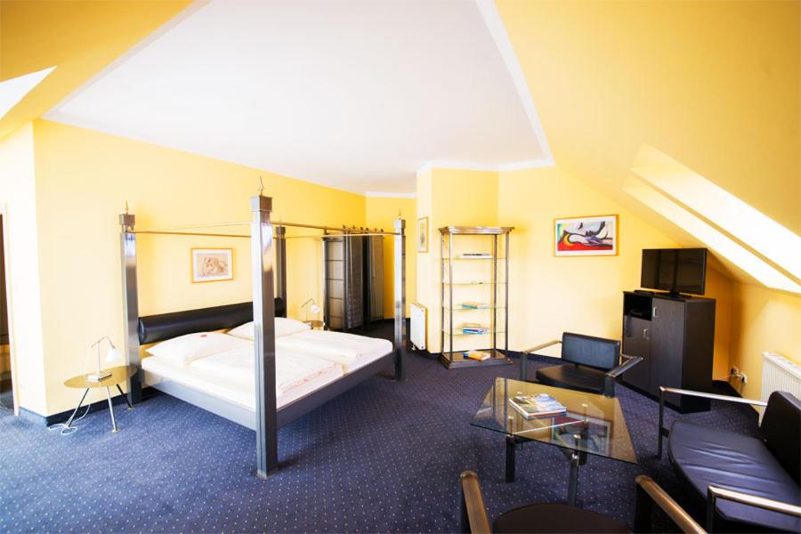 ein Hotelzimmer mit einem Bett und einem Sofa in der Unterkunft Hotel Mirage in Duisburg