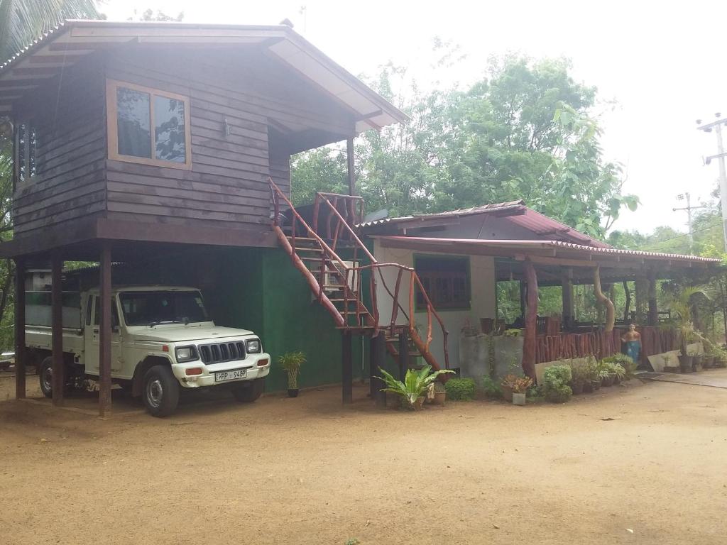a truck parked in front of a small house at Pidurangala View Home Stay in Sigiriya