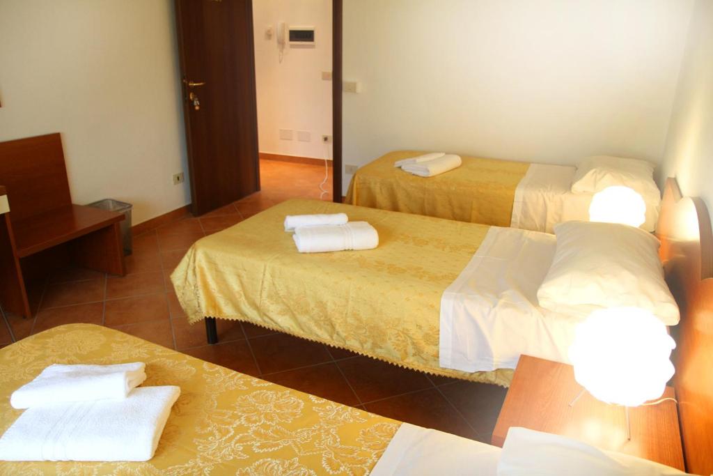 a hotel room with two beds and a mirror at B&B Music in Milan