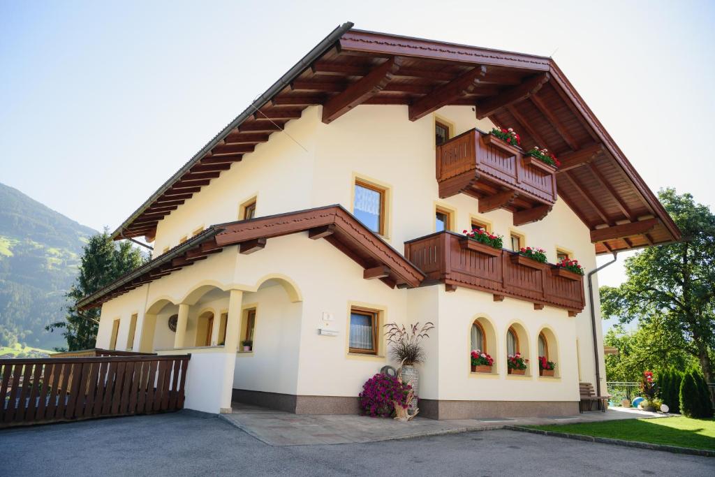a house with a balcony on top of it at Appartements Spitaler in Ried im Zillertal