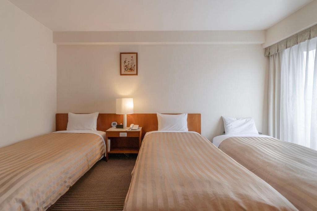 Postel nebo postele na pokoji v ubytování Hotel Gimmond Kyoto