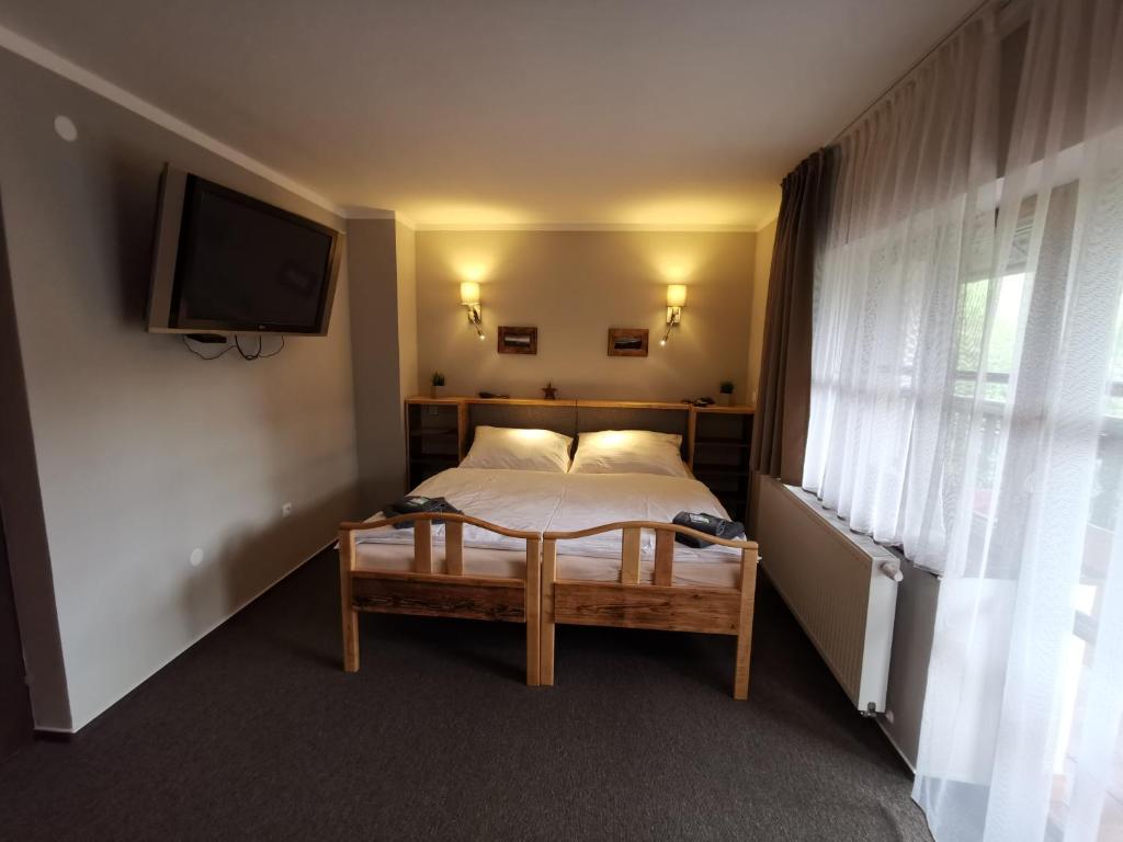 Postel nebo postele na pokoji v ubytování Hotel STARÝ MLÝN