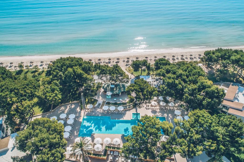 an aerial view of a resort with a pool and the beach at Iberostar Selection Playa de Muro Village in Playa de Muro