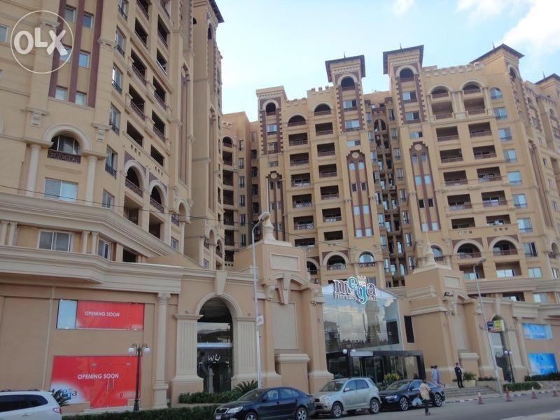 a large building with cars parked in front of it at Alexandria princess in Alexandria