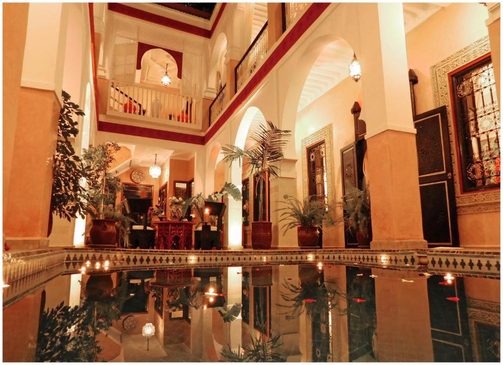 a large building with a pool in the middle of it at Riad La Rose D'orient in Marrakesh