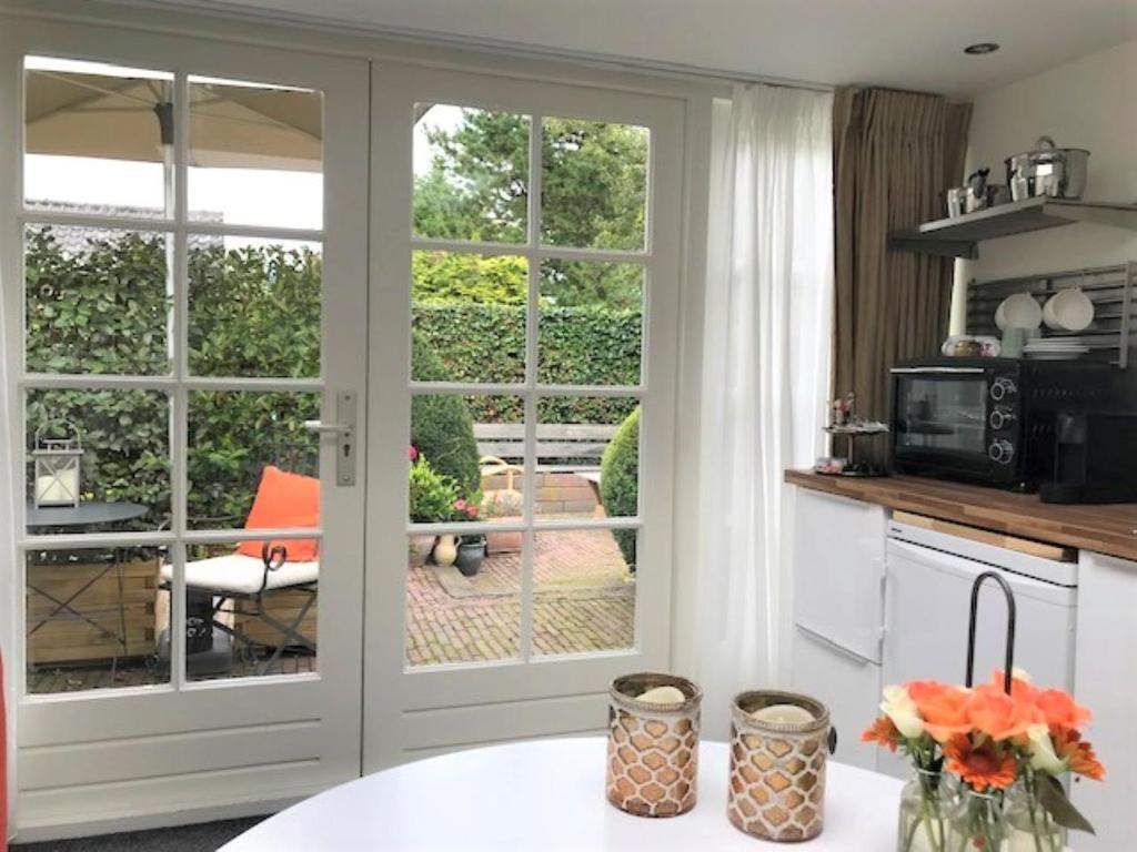 a kitchen with a sliding glass door leading to a patio at B&B Ereprijs in The Hague