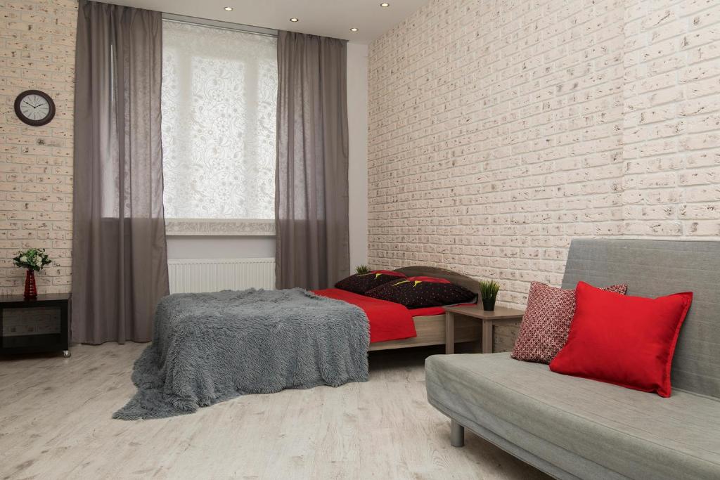 a bedroom with a bed and a brick wall at Apartments on Krasnozvezdnaya st.31 in Nizhny Novgorod