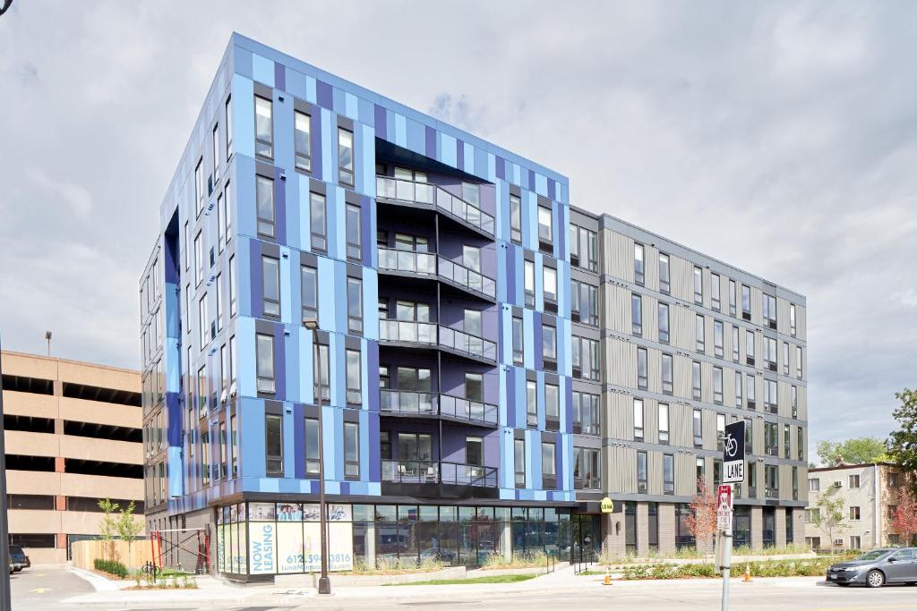 a blue building with balconies on a city street at Sonder at LUNA in Minneapolis