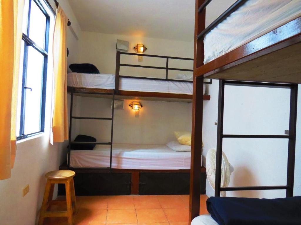 Postel nebo postele na pokoji v ubytování La Catrina Hostel
