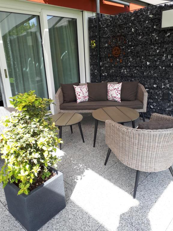 a patio with a couch and chairs and plants at Bad Säckingen - Sie werden sich hier wohl fühlen in Bad Säckingen