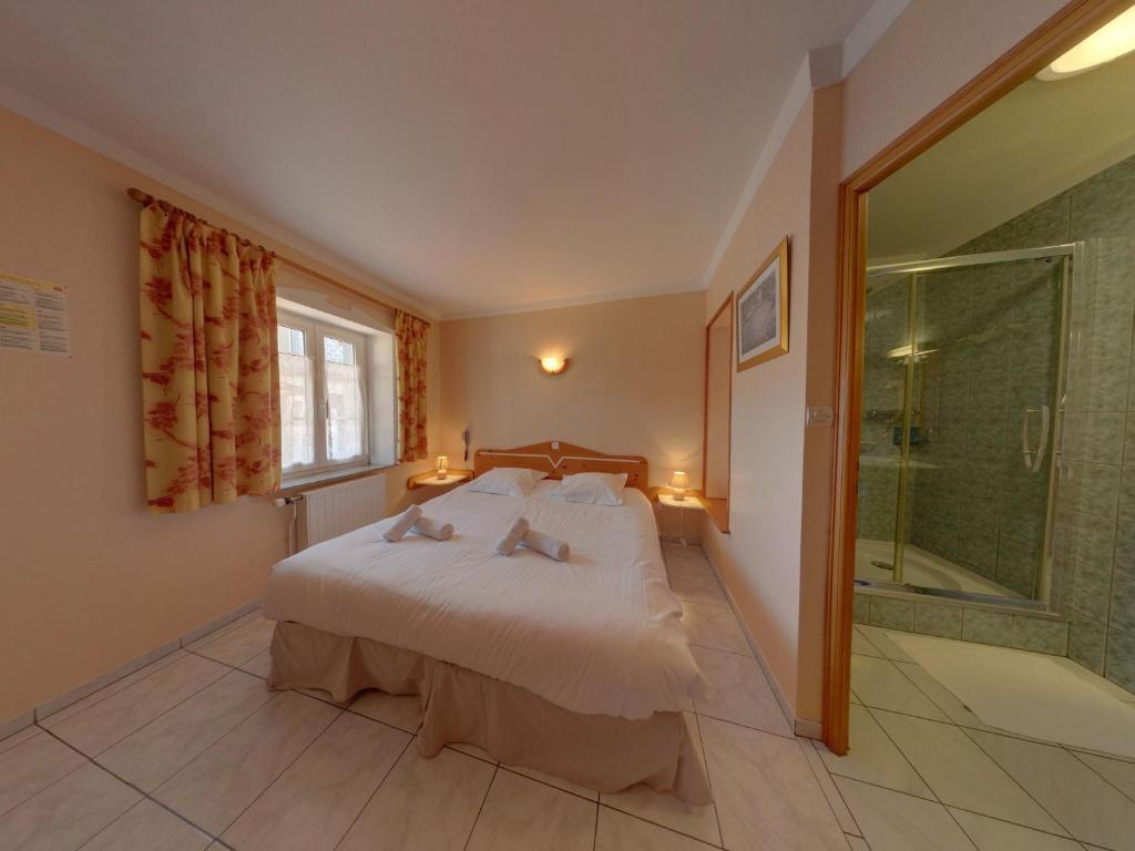 Postel nebo postele na pokoji v ubytování LOGIS - Hôtel & restaurant "L'envie des mets"