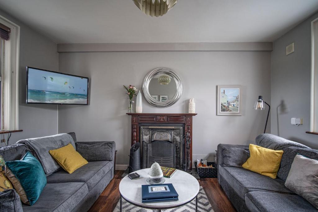 a living room with two couches and a fireplace at Doorly Park in Sligo