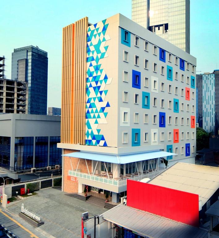 a building with blue and white squares on it at Dafam Express Jaksa Jakarta in Jakarta