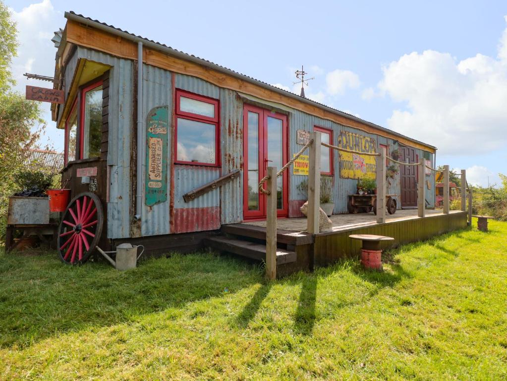 a tiny house is sitting on the grass at Crows Cabin in Gloucester