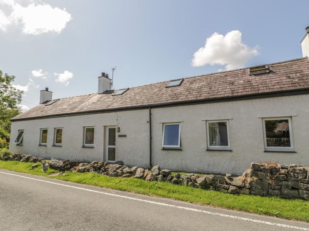 a white house on the side of a road at Ael Y Bryn in Menai Bridge