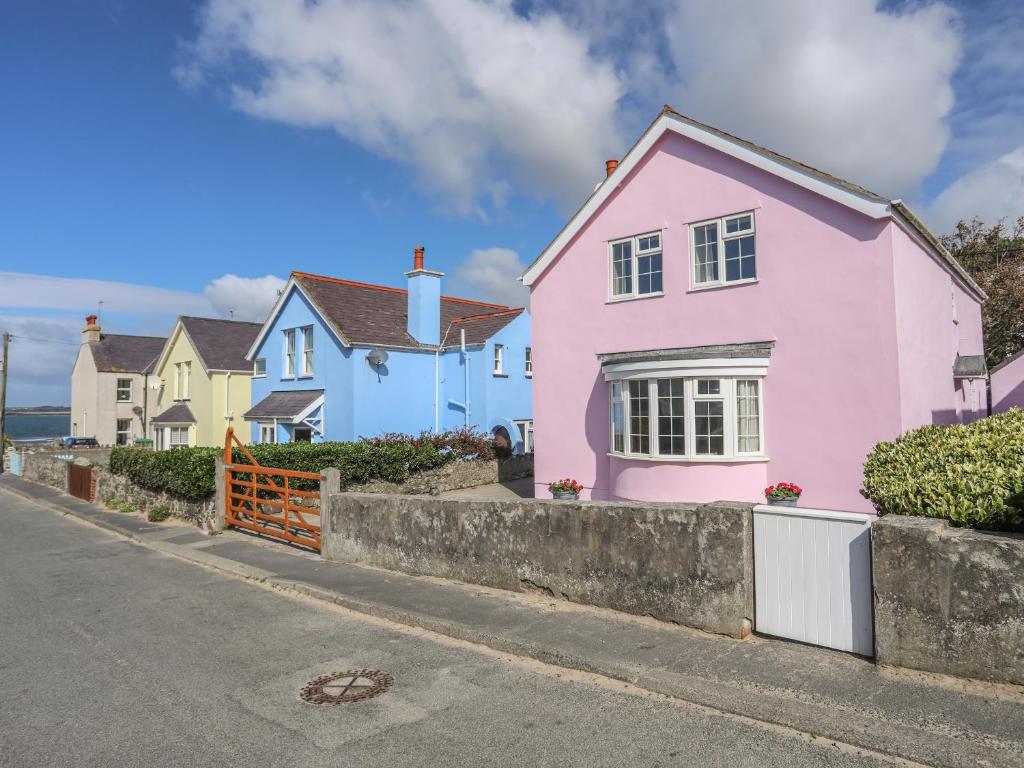 a pink house on the side of a street at The Pink House in Rhosneigr