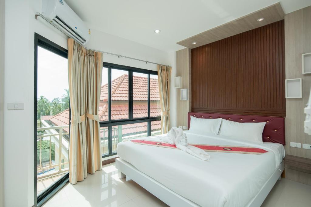 Postel nebo postele na pokoji v ubytování Baan Thai Beach Side Residence
