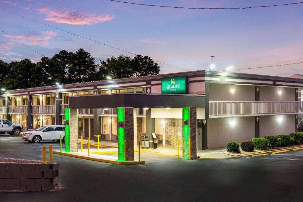 a hotel front of a building with green lights at Quality Inn Concord Kannapolis in Concord
