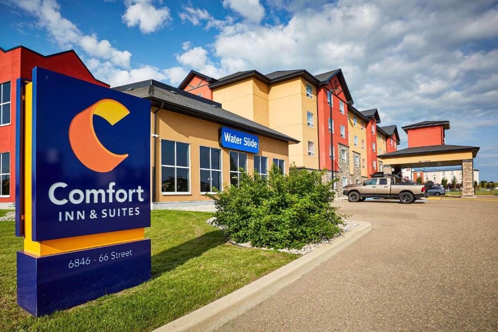 a c comfort inn and suites sign in front of a building at Comfort Inn & Suites Red Deer in Red Deer